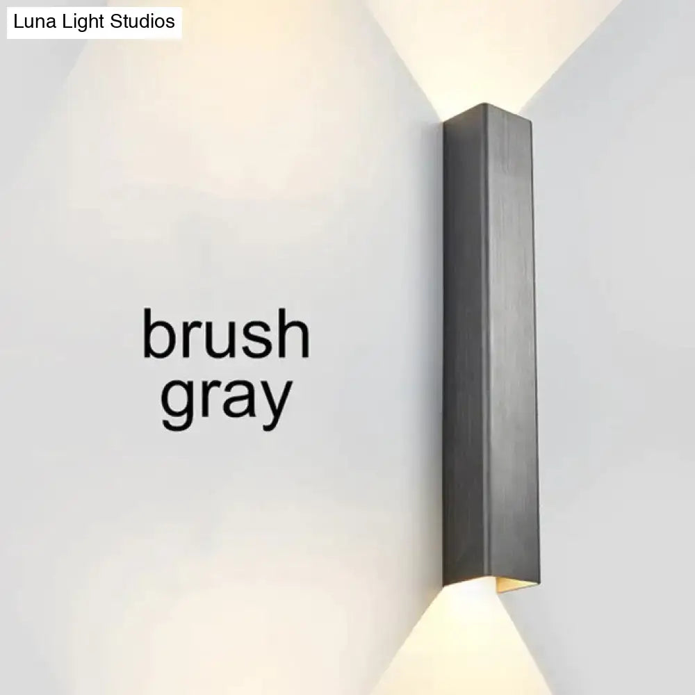 Modern brushed aluminum rectangular wall sconce with a gray matte finish for bedroom ambient lighting