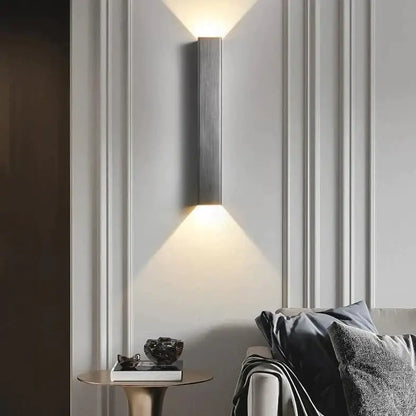 Modern brushed aluminum rectangular wall sconce with sleek metallic finish and two angled light beams for bedroom ambient light