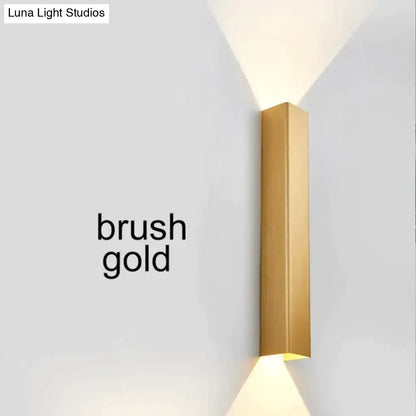 Modern brushed aluminum rectangular wall sconce with gold finish and minimalist design for bedroom ambient lighting
