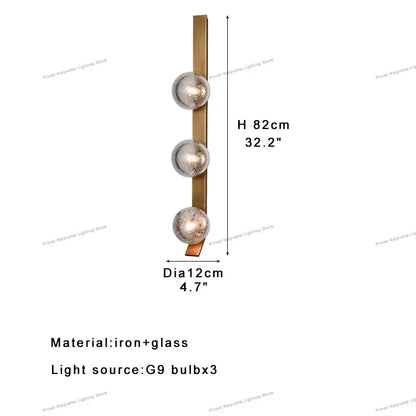 Modern brushed brass wall sconce lamps with three frosted glass globes ideal for bedroom lighting