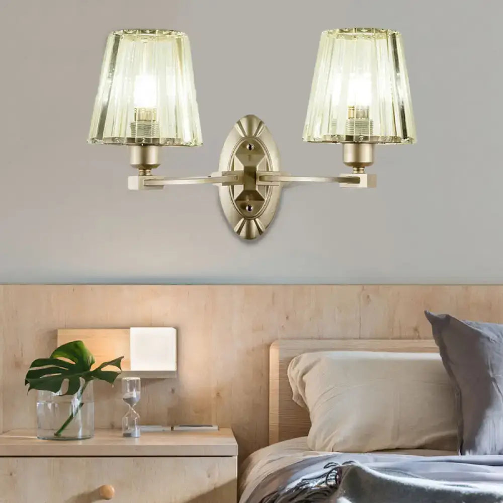 Modern brushed brass wall sconce with two fluted translucent green glass shades for bedroom wall lighting fixture