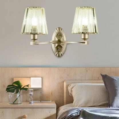 Modern brushed brass wall sconce with two fluted translucent green glass shades for bedroom wall lighting fixture