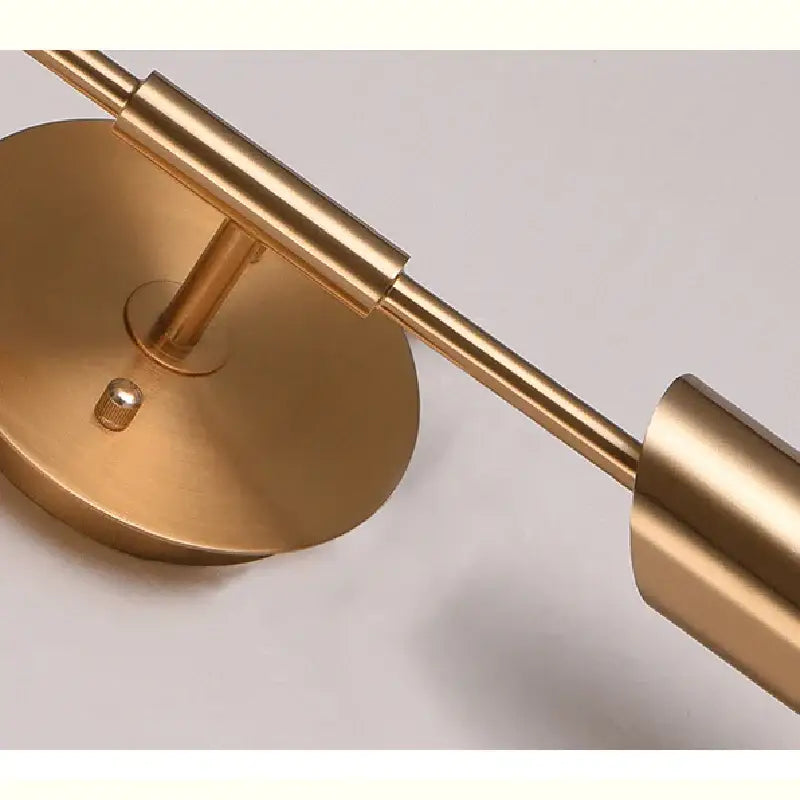 Modern brushed brass golden wall lamp with brass finish, sleek cylindrical arms, and circular base for luxury decorbites wall lamp