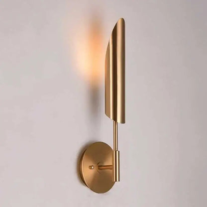 Modern brushed brass golden wall lamp with a sleek leaf-shaped shade and circular base for luxury bedroom decorbites wall lamp