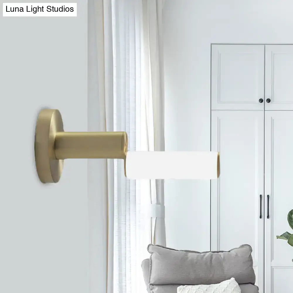 Modern brushed brass led door handle with gold metal finish and gold-toned wall sconce with acrylic shade