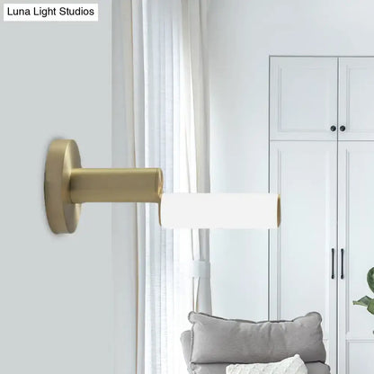Modern brushed brass led door handle with gold metal finish and gold-toned wall sconce with acrylic shade