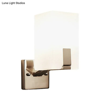 Modern brushed nickel wall sconce with rectangular frosted glass shade showcasing light type for bedroom use
