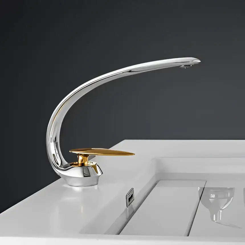 Modern brushed gold basin faucet with chrome-finished curved spout and gold-toned flat disc handle decorbites brushed gold