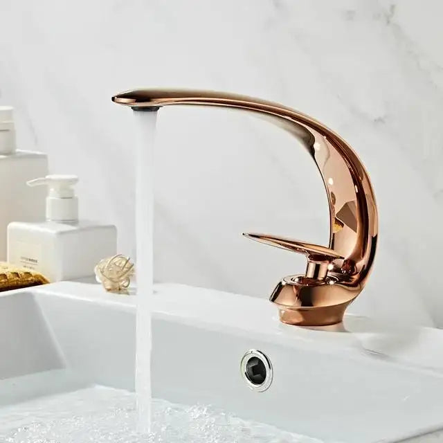 A sleek modern brushed gold basin faucet with a rose gold polished metallic finish for bathroom sinks decorbites brushed gold
