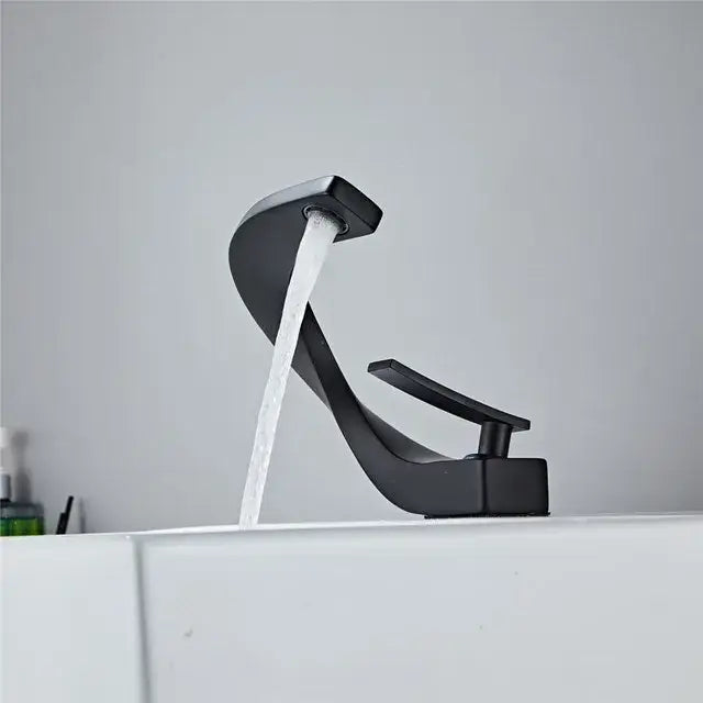 Modern black matte-finish basin faucet with sleek curved spout and minimalist design from decorbites basin faucet collection