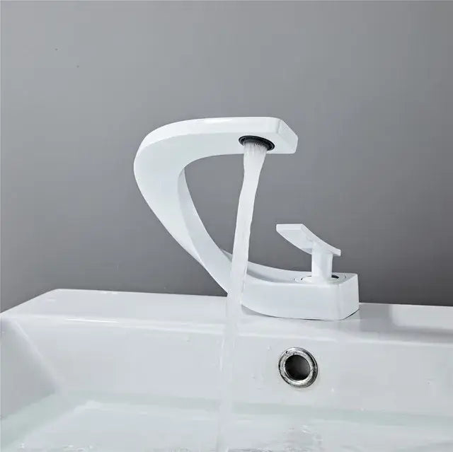 Modern white ceramic basin faucet with sleek curved design and minimalist handle for decorbites basin faucet