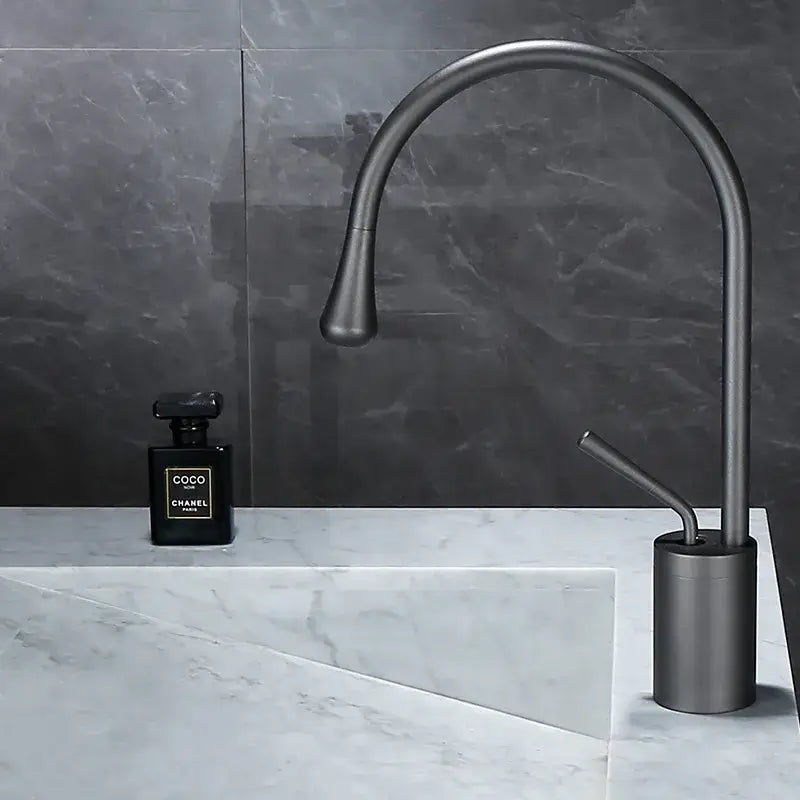 Modern matte black basin faucet with sleek curved spout and cylindrical base in decorbites brushed gold bathroom style