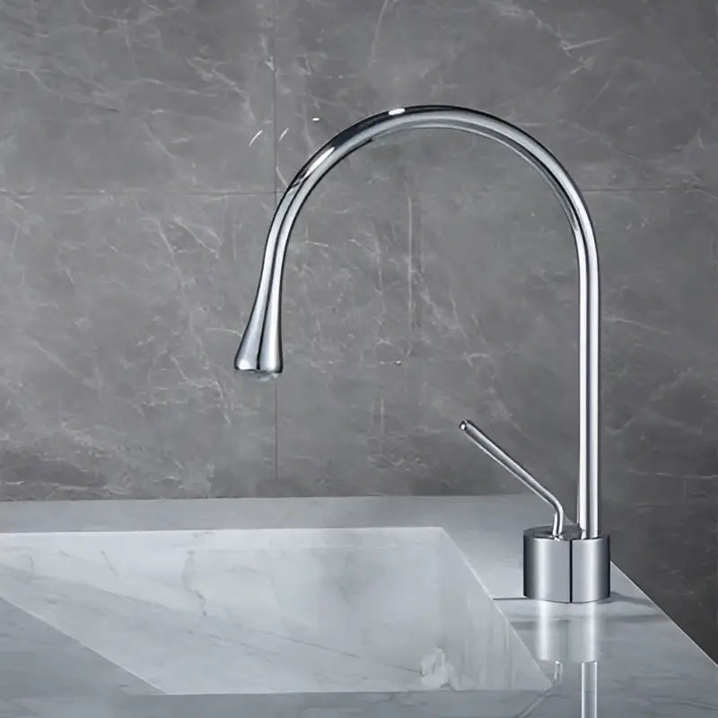 Modern chrome-finished basin faucet with a sleek curved spout for kitchen use by decorbites brushed gold collection