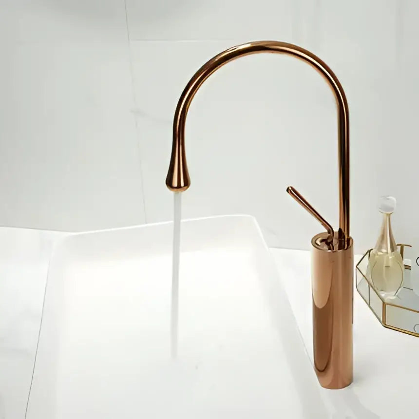 Modern brushed gold basin faucet with copper finish sleek curved spout and cylindrical base decorbites brushed gold design
