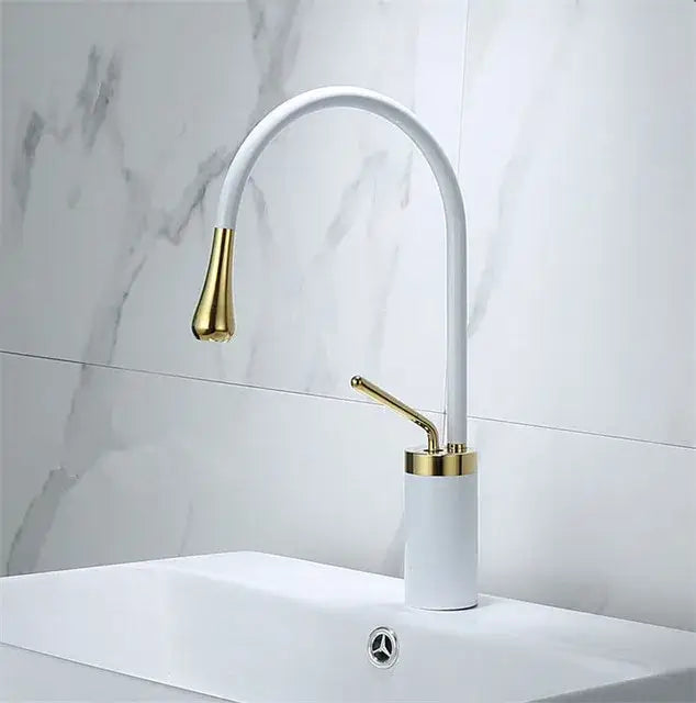 Modern brushed gold basin faucet with white and gold curved swivel spout and cylindrical base for bathroom decorbites