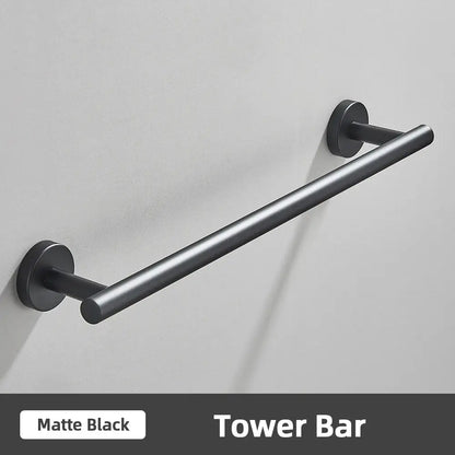 Matte black metal tower bar with sleek cylindrical design in modern brushed gold stainless steel bathroom accessories set