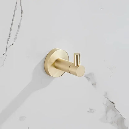 Gold-toned wall-mounted hook with circular base and cylindrical arm from modern brushed gold bathroom hardware set