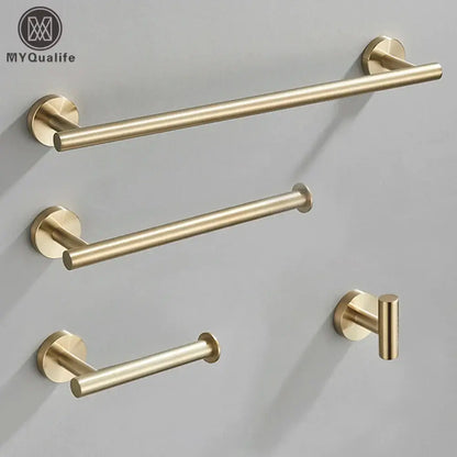 Modern brushed gold bathroom hardware set featuring a gold-toned brushed metal towel rack with matching hooks and mounts