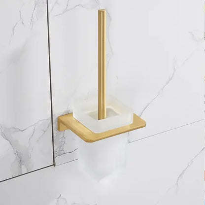 Modern brushed gold bathroom set with gold-toned toilet brush holder featuring a square brass base and acrylic cup