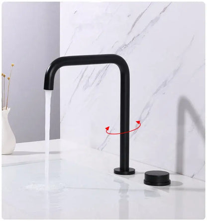 Modern brushed gold and black basin faucet with black matte curved spout and two cylindrical handles decorbites brushed gold