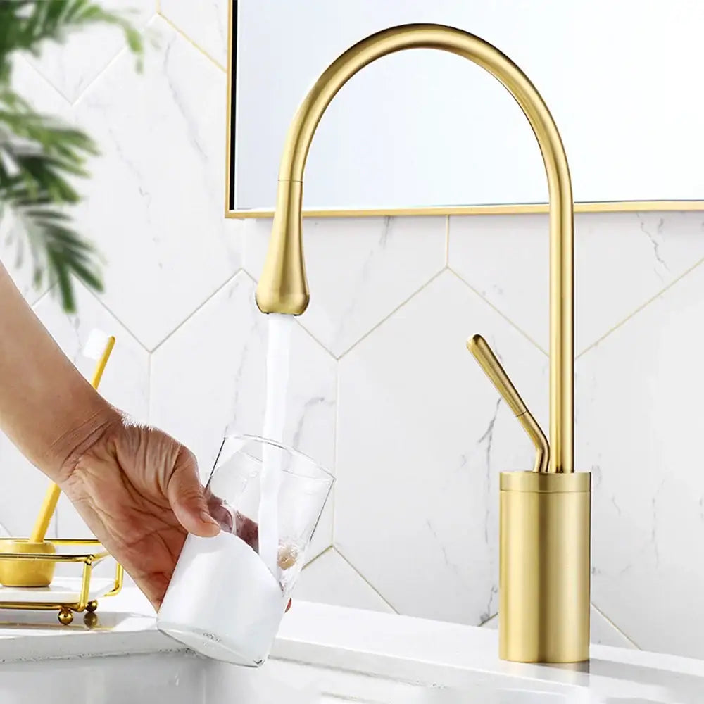 Modern brushed gold and black deck mounted kitchen faucet with single hole installation and sleek curved spout