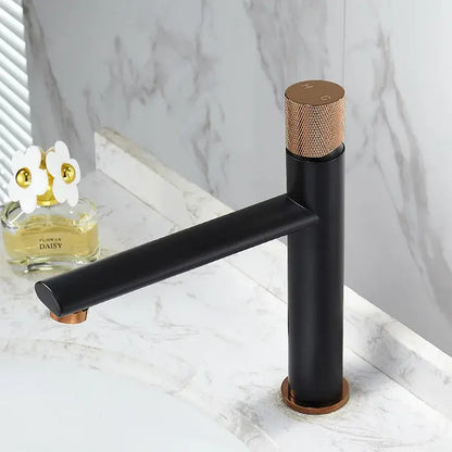 Modern brushed gold brass basin faucet with black matte finish and rose gold accents on handle base and spout tip