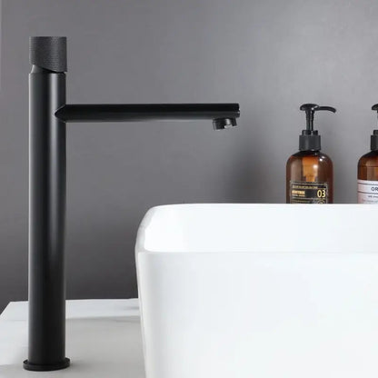 Black matte basin faucet with textured cylindrical handle in sleek modern design for brushed gold brass bathroom sink tap