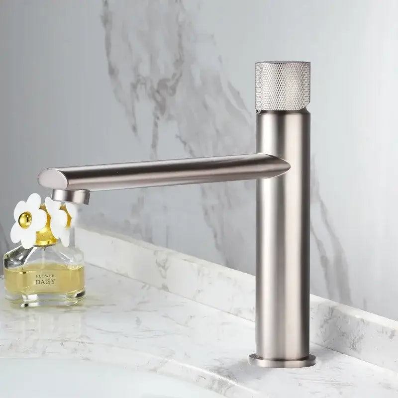 Modern brushed gold brass basin faucet with a single-handle and textured diamond-patterned knob for bathroom sink use