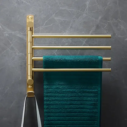 Modern brushed gold brass bath hardware set with a gold-toned four-bar towel rack holding a deep teal textured towel