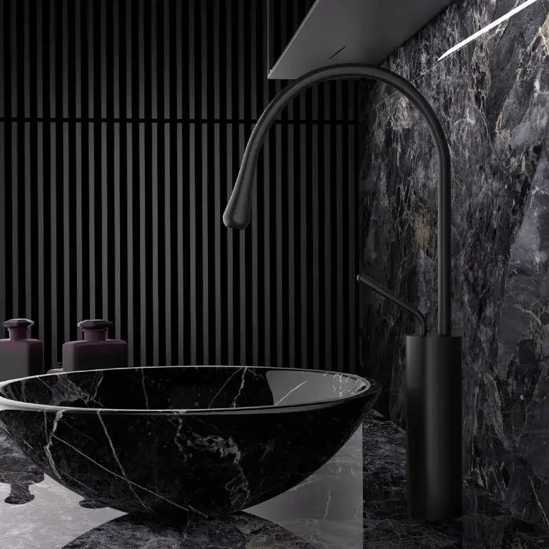 Black marble vessel sink with sleek curved matte black faucet and modern brushed gold brass kitchen sink tap