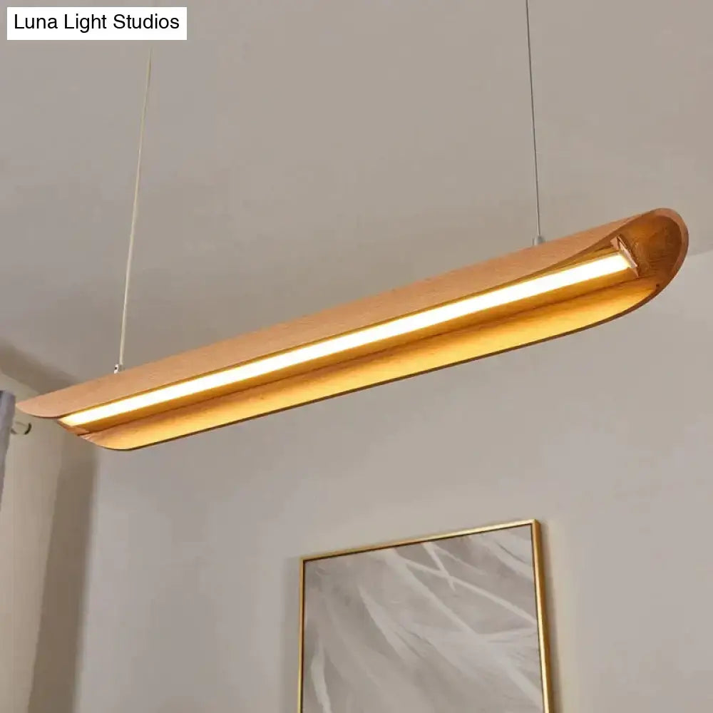 A sleek modern kitchen island light with warm brushed gold finish and curved wooden design for wood chandeliers kitchen