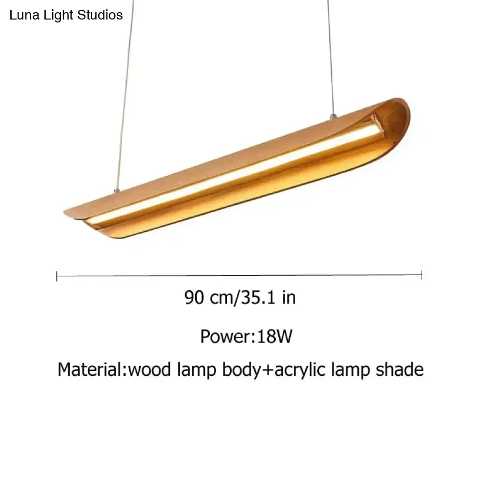 A modern brushed gold kitchen island light with a curved wooden body and acrylic shade for wood chandeliers kitchen use