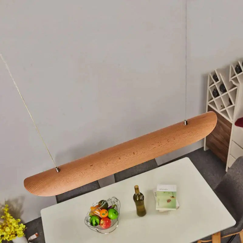 A sleek light brown wooden pendant lamp with an elongated oval design for kitchen island light fixtures chandelier