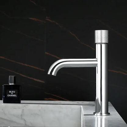Modern brushed gold single handle basin faucet with knurled textured handle and sleek minimalist design