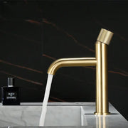 Modern brushed gold single handle basin faucet with a textured knurled handle and sleek cylindrical spout
