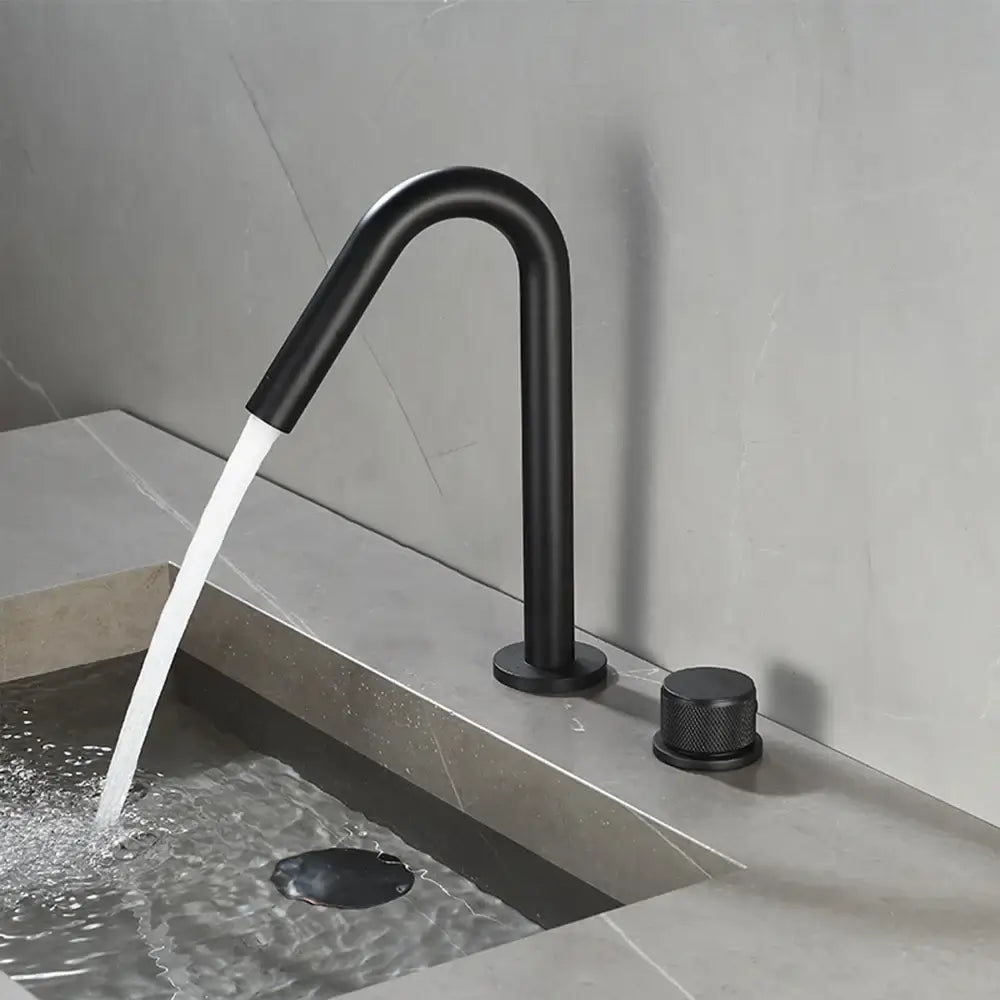 Modern brushed gold single handle bathroom basin faucet with black matte finish curved spout and textured knob premium ceramic valve