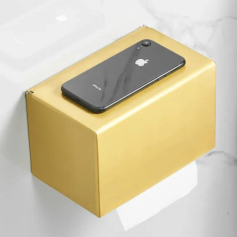 Modern brushed gold rectangular paper holder with a sleek minimalist design for toilet paper in bathroom use