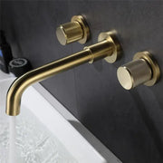 Modern brushed gold wall mount faucet with brass finish and textured cylindrical handles for bathroom use
