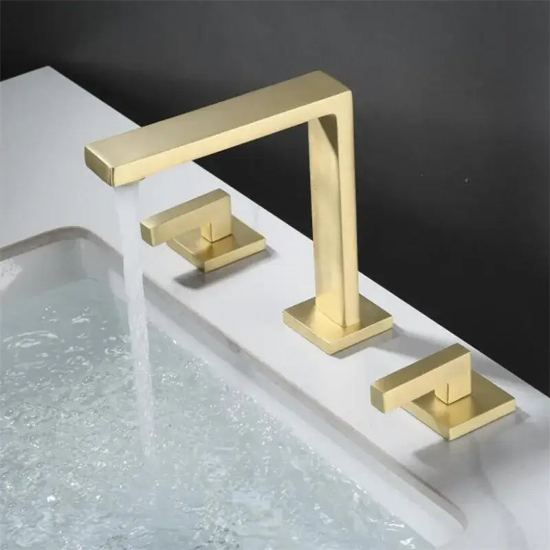 Modern brushed gold basin faucet with two square handles and sleek minimalist decorbites brushed gold design