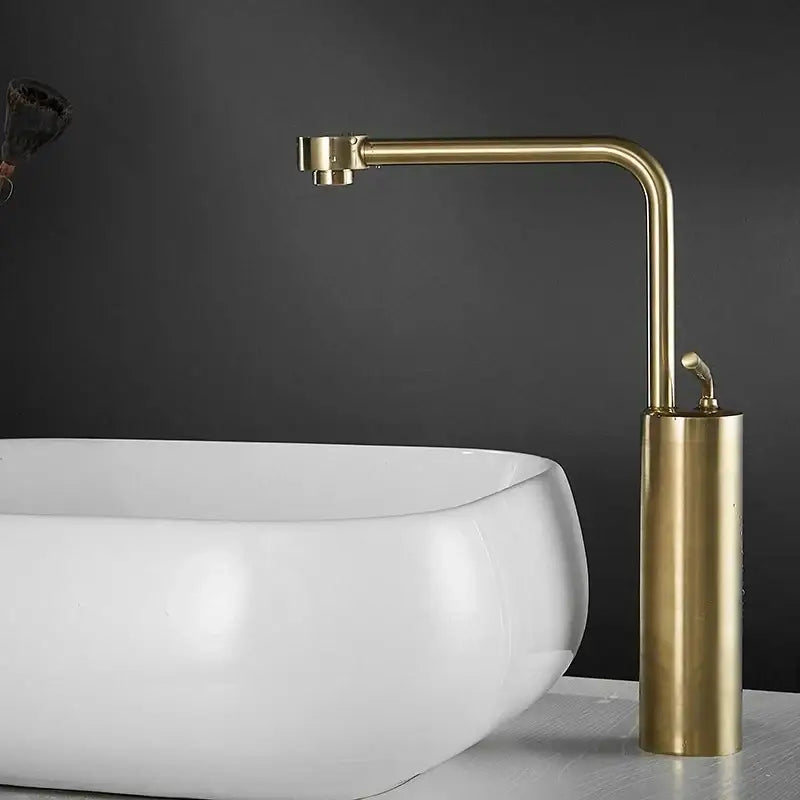 Modern brushed gold waterfall faucet swivel sink with a brass-finished cylindrical base and curved spout by decorbites