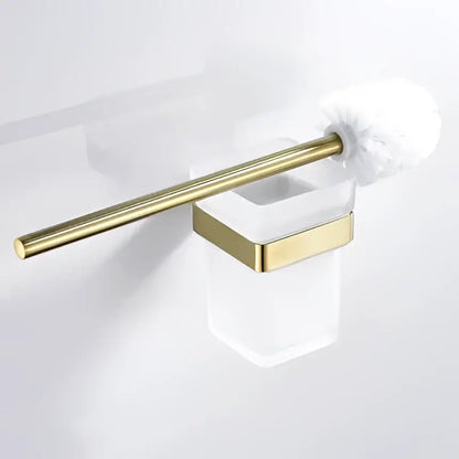 Modern brushed matt gold decorbites bath set featuring a gold-toned toilet brush with white fluffy bristles in a glass holder