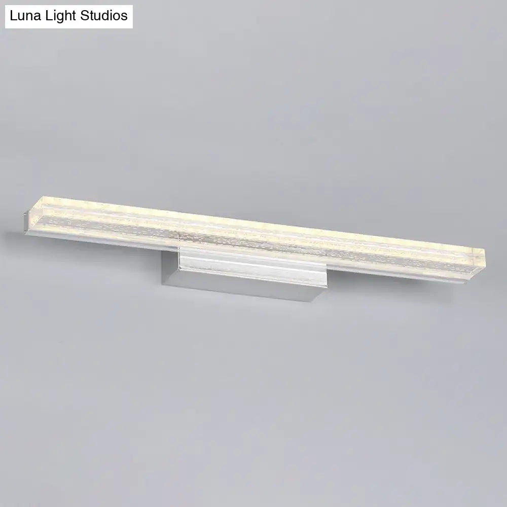 Modern chrome finished wall mounted vanity sconce with a sleek rectangular design and acrylic shade diffuser