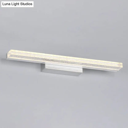 Modern chrome finished wall mounted vanity sconce with a sleek rectangular design and acrylic shade diffuser
