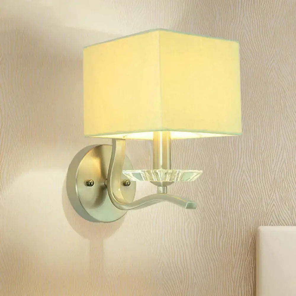 Modern brushed nickel bedside wall lamp with crystal features a cube bedside wall design with a beige fabric shade