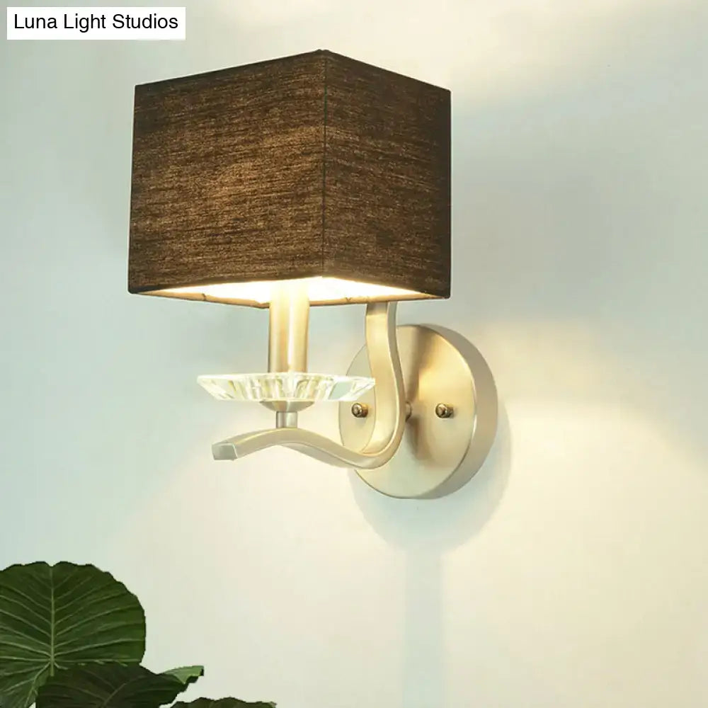 Modern brushed nickel bedside wall lamp with a cube bedside wall design featuring a brown fabric shade and crystal accent