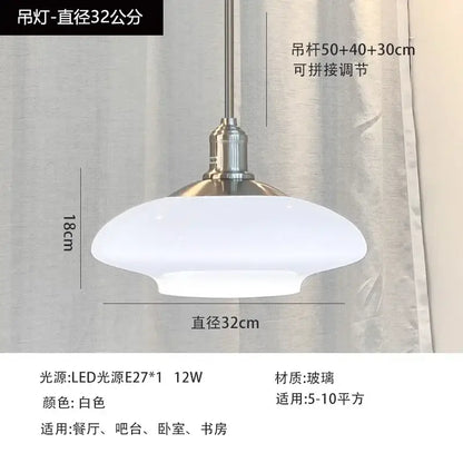 A sleek white glass pendant light with brushed nickel fixture and dome shade for modern kitchen indoor lighting