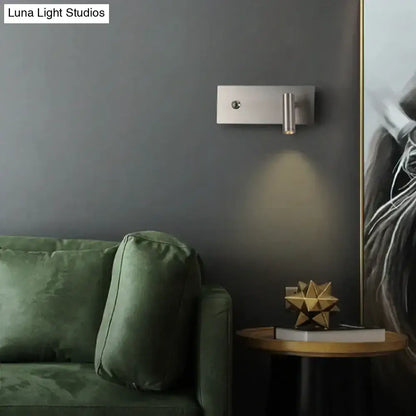 Modern brushed nickel led dimmable reading wall light with a sleek rectangular base and cylindrical light head for bedroom use