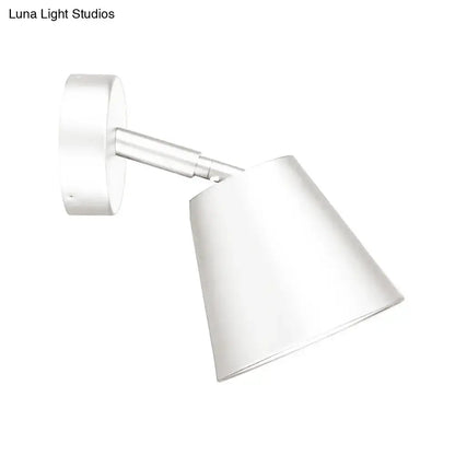 Modern brushed nickel tapered wall light with a white conical wall sconce and sleek metallic arm for bathroom use