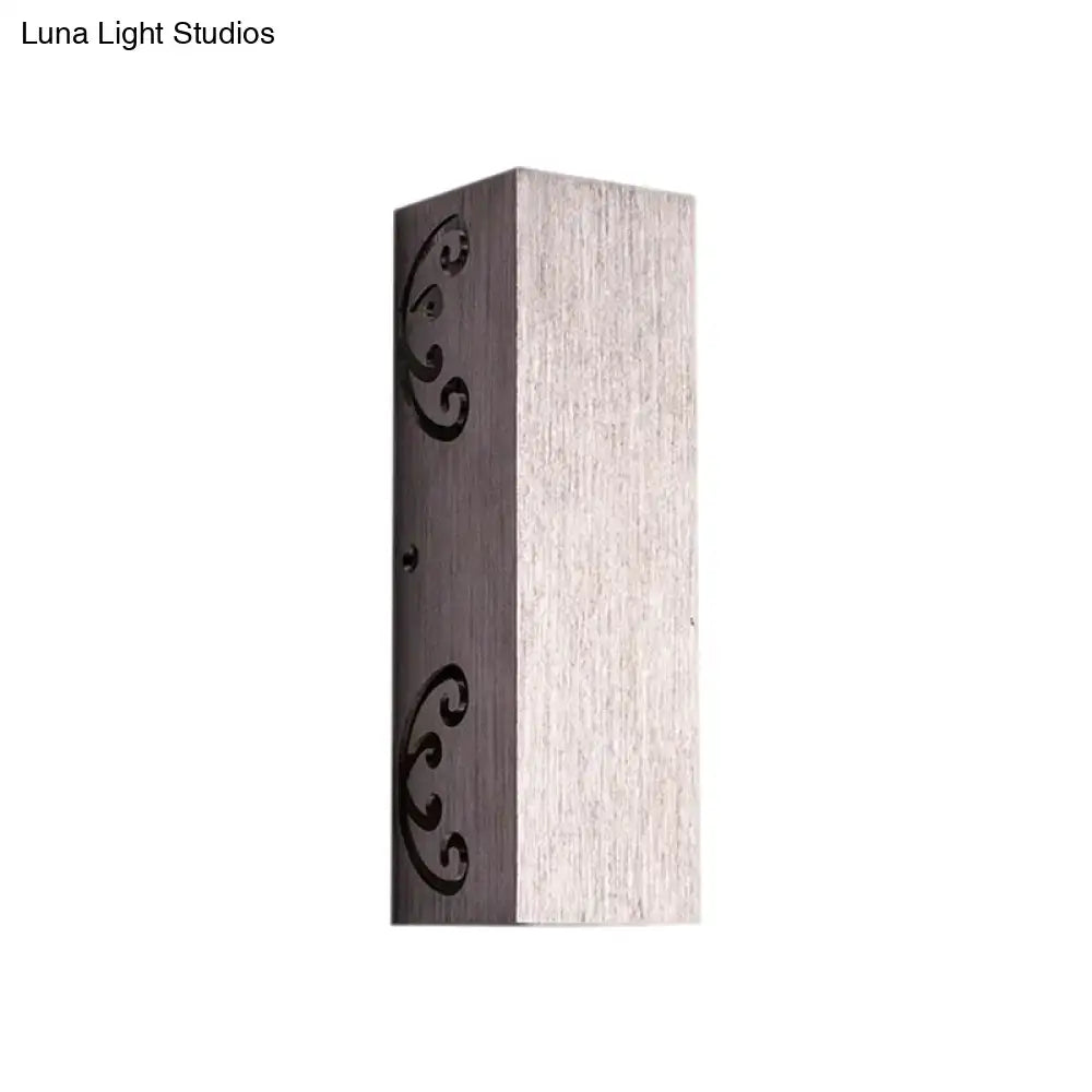 Modern brushed silver wall sconce with butterfly design and bulb base featuring brushed metallic finish and black scrollwork