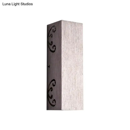 Modern brushed silver wall sconce with butterfly design and bulb base featuring brushed metallic finish and black scrollwork